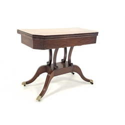  Regency mahogany card table, with rosewood cross banded and string inlaid top hinged to reveal baize lined playing surface, raised on four splayed supports with brass hairy paw castors, W91cm, H71cm, D45cm  