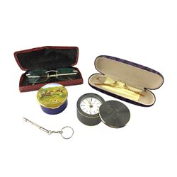 Tiffany & Co. steel and brass portable alarm clock with rotating cover, Swiss Quartz movement, Ashley enamel box, pair of Cartier frameless prescription glasses with titanium temples and bridge, no. 135, another pair of glasses etc
