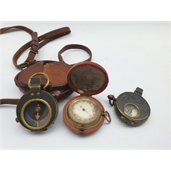 World War I marching compass in a leather case inscribed C & R Brinsley 1916, another and a pocket barometer in outer leather case 
