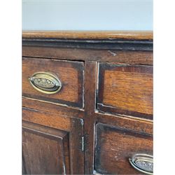 George III oak dresser, rectangular tope crossbanded with mahogany, fitted with five drawers and two cupboard doors, raised on bracket feet