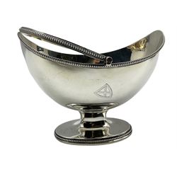 George III silver oval sugar basket engraved with a shield shape crest, with bead edge, loop handle and short pedestal foot L15cm London 1786 Maker possibly Henry Chawner 8oz 