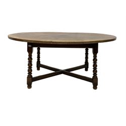 Titchmarsh and Goodwin solid oak dining table, the oval top raised on bobbin turned and block supports, united by 'X' stretcher, with manufacturers label 