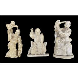 19th century Japanese carved ivory okimono of a seated figure with a monkey on his shoulder and with signature mark to base H15cm, another of a figure with two children, signed H15cm and another of a figure with a dragon, signed H11cm (3)