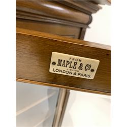 Maple & Co - Late Victorian dwarf breakfront bookcase, moulded cornice over leaf carved cushion frieze, four bevel glazed doors enclosing eleven shelves, flanked by fluted pilasters, raised on plinth base, bearing Ivorine makers label W199cm, D44cm, H122cm