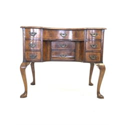 18th century walnut and oak serpentine lowboy, the cross banded, herringbone inlaid and moulded top over nine drawers, raised on cabriole supports 