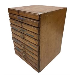 A ten drawer printers chest containing a quantity of metal stamps/ matrices, H59cm, W44.5cm, D44cm