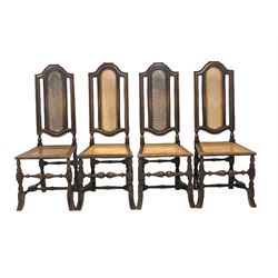 Set of four Victorian oak high back hall chairs of an earlier design, shaped crest rail over cane back and seat panel, raised on turned and block supports terminating in splayed and reeded carved feet 