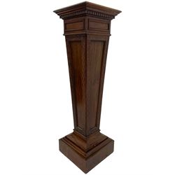 Edwardian mahogany pedestal stand, moulded square top on tapered pedestal decorated with blind fretwork, on stepped and moulded square base