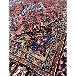 Persian Sarouk full pile red ground Persian Sarouk carpet, with floral medallion 305cm x 200cm