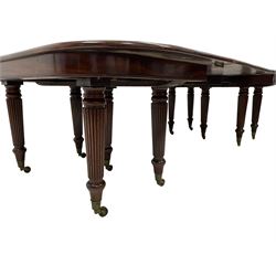 19th century mahogany dining table, rectangular moulded top with rounded corners, two D-ends each on five turned and reed carved supports with brass cups and castors, pull-out extension supports, with two additional leaves