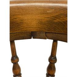 Smokers bow chair, the spindle back over elm seat, raised on turned supports, united by metal and wooden stretchers 