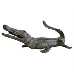 Bronze garden water fountain in the form of a crocodile, the open jaw fitted with water pipe, whipped and raised tail 