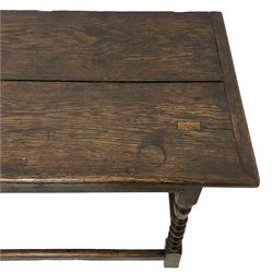 17th century oak side table, cleated and pegged two plank top over moulded front rail, on bobbin turned supports joined by plain stretchers