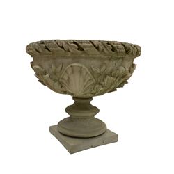 Composite stone urn, foliate and ribbon cast edge over a shell and floral relief