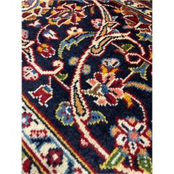 Hand knotted Persian rug from Kashan region, with one navy medallion in red field and navy border with all over floral design 270cm x 357cm 