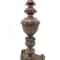 Antique mahogany standard lamp, turned column profusely carved with leaves, flutes and lobes, over a trefoil base with further carvings of scrolled acanthus leaves and cartouches, raised on three paw supports, with a decorative lampshade 
