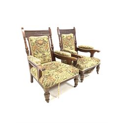 Pair of Victorian mahogany carved open armchairs, with needlework upholstery, raised on turned and reeded front supports with castors, W70cm