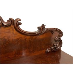 Early Victorian figured mahogany sideboard, raised back carved with foliage scrolls, fitted with three cushion frieze drawers with over twin pedestals, each with waisted door panels, enclosing shelves, on skirted base 