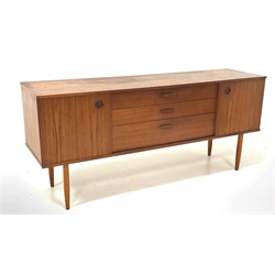 Mid 20th century teak sideboard, two sliding doors enclosing fixed shelves, flanking three graduated drawers, raised on tapering supports 