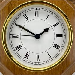 Mouseman - oak and brass wall clock, circular Roman dial in brass drum on moulded octagonal mount carved with mouse signature, fitted with battery operated Quartz movement, by the workshop of Robert Thompson, Kilburn 