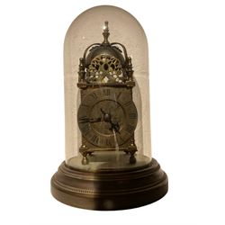 English - 20th century 8-day replica Lantern clock, with a French twin train striking movement and lever platform escapement, striking the hours and half hours on a visible silvered bell, with a silvered chapter ring with Roman numerals and gothic steel hands, under an associated glass dome and 7” spun brass base.
