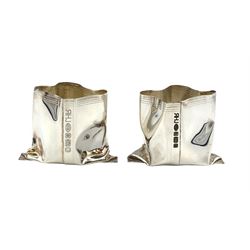 Pair of novelty silver vases by Rebecca Joselyn modelled as crumpled bags, H4.5cm hallmarked Sheffield 2013. Rebecca Joselyn studied at Sheffield Hallam University and graduated in 2006.  She has won numerous awards for her 'From the Shed' and 'Packaging' collections