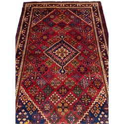 Persian Joshagan crimson round rug, the field decorated with a central lozenge and surrounded by diamonds containing various stylised plant or flower head motifs, the indigo border with trailing curling vines and palmettes