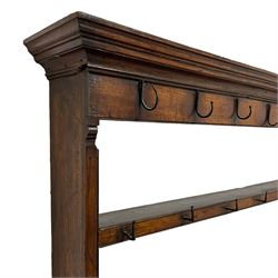 18th century oak dresser, projecting moulded cornice over two rows of wrought metal hooks and two tiers, the base with rectangular top over three cock-beaded drawers, four turned front pillar supports on boarded base, turned feet