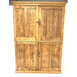 Victorian style pine kitchen press, top section fitted with two panelled doors enclosing two shelves, two doors under enclosing another shelf, on a skirted base W141cm, H199cm, D40cm