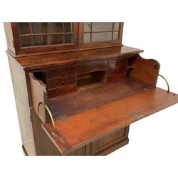 Early Victorian mahogany bookcase secretaire, the projecting cornice over two astragal glazed doors, enclosing three adjustable shelves, the lower section fitted with fall front secretaire drawer revealing small drawers, figured panelled double cupboard below, on plain plinth base