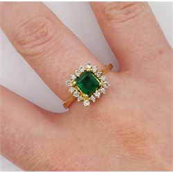 Gold rectangular cut emerald and round brilliant cut diamond cluster ring