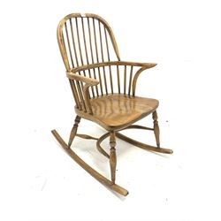 20th century elm Windsor style rocking chair, double hoop and spindle back, bentwood arm terminals, saddle seat, raised on turned supports with crinoline stretcher W 60cm