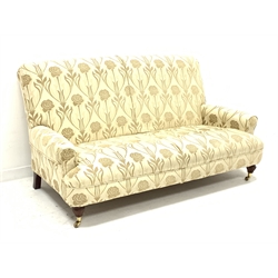 Multi-York 'Grosvenor' three seat sofa, upholstered in cream floral patterned removable cover, turned and reeded front supports with brass castors, W178cm, D100cm
