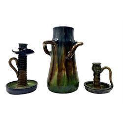 Three pieces of Art Nouveau pottery, probably Belgian, comprising a three-handled vase H28cm of tapered form, candlestick and chamber stick (3) 