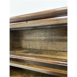 Globe Wernicke - early 20th century oak four sectional stacking library bookcase, each enclosed by glazed up-and-over doors, fitted with single drawer to base