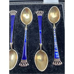 Set of six silver coffee spoons with blue and green enamel terminals, cased Birmingham 1935 Maker Walker and Hall and a set of six silver gilt and enamel coffee spoons marked 'Denmark Sterling' 
