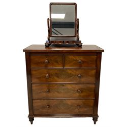 Victorian mahogany straight-front chest, fitted with two short over three long graduating drawers, raised on turned feet (W110cm D58cm H121cm); and a Victorian mahogany dressing table mirror, rectangular plate on scrolled swing supports, shaped platform base (W62cm H69cm)