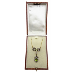 Peridot and diamond bow pendant, on gold chain necklace stamped 375