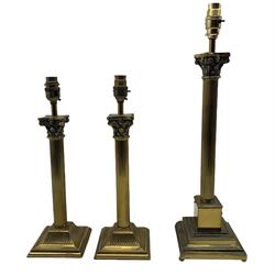 Pair of brass Corinthian column table lamps on square bases together with another similar lamp all with shades max H52cm