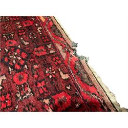 Iranian Shahsavan magenta ground runner rug, the field decorated with all-over geometric designs and stylised plant motifs, the double-band border with matching decoration