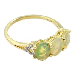 9ct gold three stone opal ring, with pierced diamond set shoulders, hallmarked 