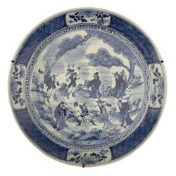Chinese Qing Dynasty 'Eight Immortals' blue and white charger, centrally painted with a scene of the eight immortals in a garden setting beneath a pine tree, within a greek key and panelled border, Da Qing Kangxi Nian Zhi six character mark beneath, D41cm