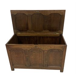 20th century oak blanket box, tripled panelled hinged lid and front, solid ends, on stile supports 