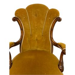 19th century walnut framed open armchair, scallop shaped  back with c-scroll uprights, upholstered in yellow buttoned velvet fabric with sprung seat, arm terminals carved with acanthus leaves, raised on scrolling cabriole supports with castors