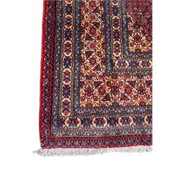 Fine Persian Bijar rug, red ground with central medallion, the field decorated with herati motifs, multi-band border with repeating design