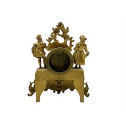 A late 19th century French gilt spelter mantle clock with an 8-day timepiece movement, decorative case with swags and standing figures of a gallant and lady in 18th century dress, with an enclosed Parisian drum movement and a coloured porcelain dial, roman numerals and a semi-circular spray of flowers, with brass hands in the gothic style. With pendulum and key. 
With a continental Sitzendorf porcelain boudoir clock depicting musical putti and encrusted rosebuds with trailing leaves, dial within a chrome bezel and  flat glass, with Arabic numerals and minute markers, 30-hour spring driven timepiece movement wound and adjusted from the rear.   
Spelter clock H28 W26 D10
Porcelain clock H23 W13 D8



