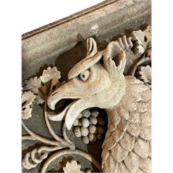 Cast stone heraldic crest, rectangular moulded form with scaled dragon within a rusticated crown, decorated with trailing branches with vine leaves and grape bunches