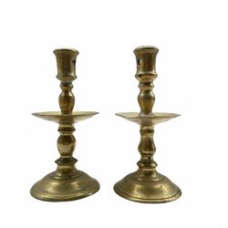 A matching pair of brass Heemskerk type candlesticks with mid drip trays, pierced sockets and baluster stems, H20cm 