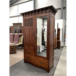 Edwardian oak double wardrobe, dentil cornice over door with floral carved panels, flanked by mirrored door, enclosing interior fitted for hanging, three drawers under W133cm, H204cm, D56cm