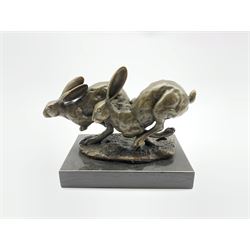 Bronze figure group, modelled as two hares in chase, signed 'Nick' and with foundry mark, upon a rectangular marble base, overall H11cm L13cm